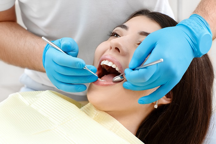 Woman in a dentists chair having treatment on her teeth